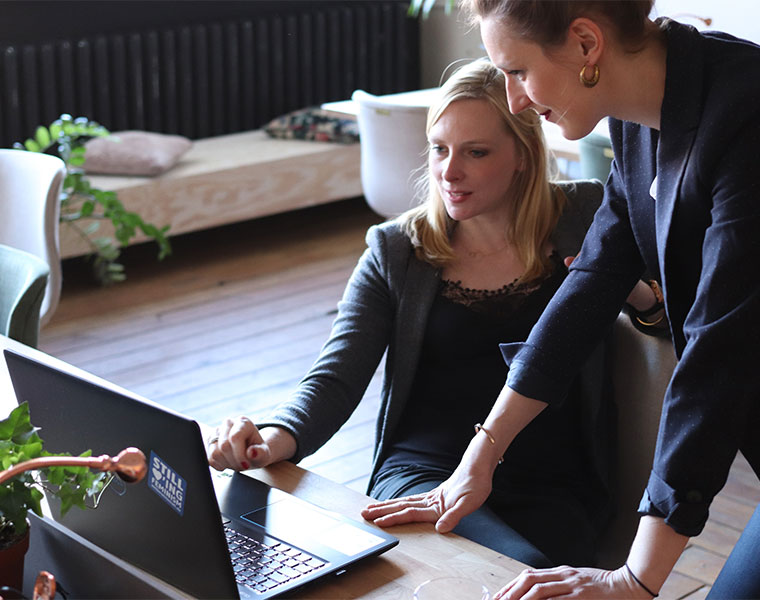 Two women looking at a laptop together